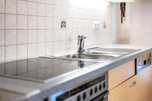 a kitchen with a sink and a stove at Haus Kofler in Racines