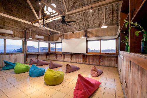 a room with colorful pillows on a tiled floor at FRii Bali Echo Beach in Canggu