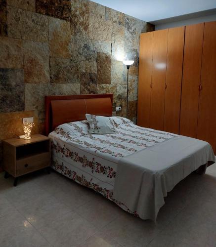 a bedroom with a bed and a cabinet and a table at Mi isla bonita in Arrecife