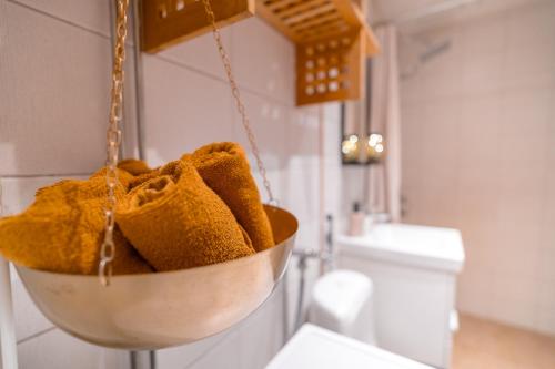 a bowl filled with brown towels in a bathroom at Nordic Gem near railway station, free parking and wifi in Rovaniemi