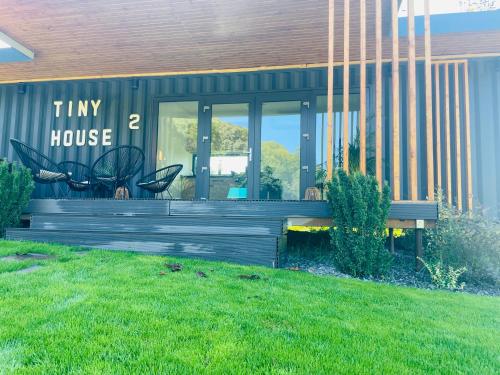 a house with a bench in front of it at Tiny House by the forest “2” 