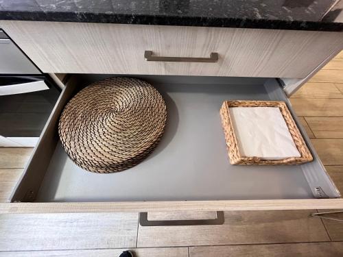 a drawer with a basket and a picture in it at luminoso apartamento 6 personas pueblo nuevo in Madrid