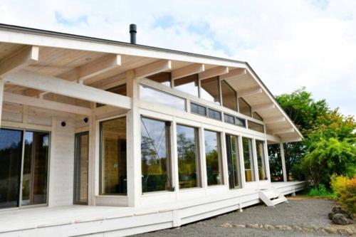 a house with large windows on the side of it at 星が瞬くフィンランドログハウス ポーラーハウス西軽井沢 in Oiwake