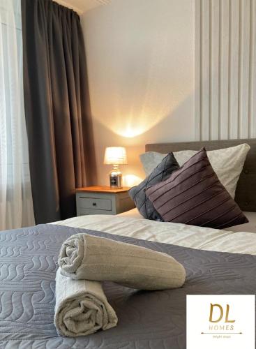 a bedroom with a bed with a towel on it at RELAX INN - Messe contactless check in in Hannover