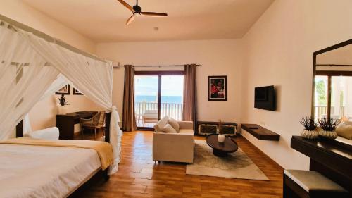 a bedroom with a bed and a view of the ocean at Dream of Zanzibar Resort & Spa - Premium All Inclusive in Uroa