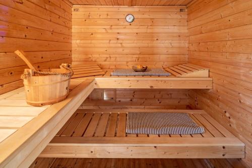 a wooden sauna with two benches and a bucket at Ferienhaus Auszeyt für Zwei in Waldeck