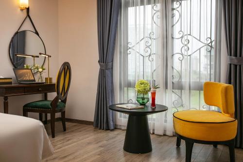 a hotel room with a table and chairs and a window at Gloud Hotel in Hanoi