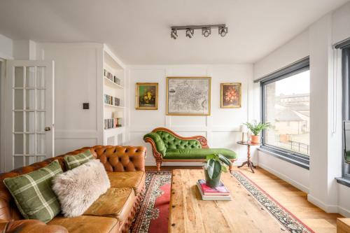 a living room with a couch and a window at The Riverside Hideaway by Calton Living in Edinburgh
