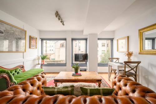 a living room with a couch and a table at The Riverside Hideaway by Calton Living in Edinburgh