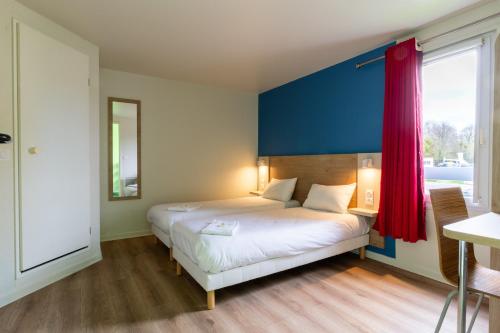 a bedroom with a bed with a red curtain at BRIT Hotel Rouen Nord - Barentin in Barentin