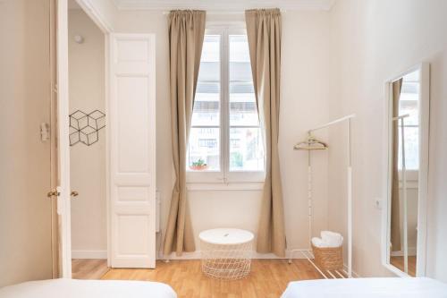 a white room with a window and a bed at Eixample8 in Barcelona
