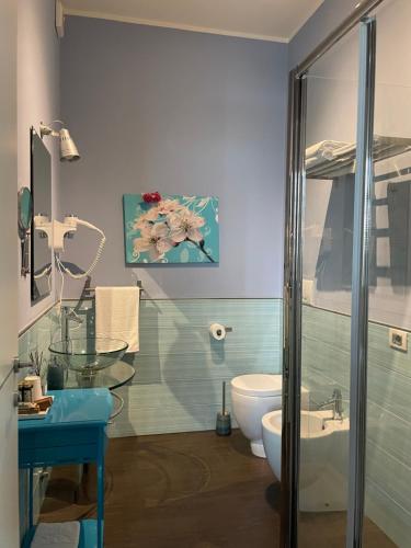 a bathroom with a sink and a toilet and a shower at Bigatt Bed & Breakfast in Vanzago