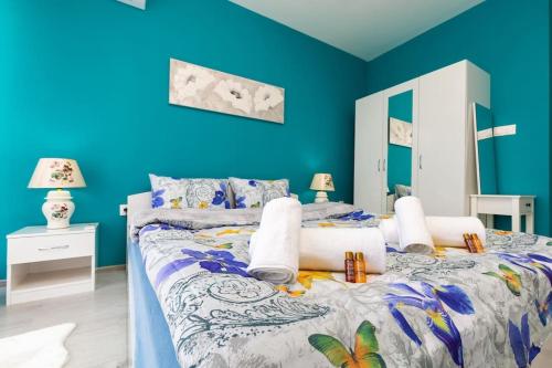 a bedroom with blue walls and a large bed at Comfy Apartment with Private Parking in Plovdiv