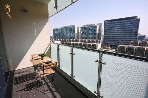 a balcony with a bench and a view of a city at 1BR Apartment Retreat for Your Getaway In Al Muneera in Abu Dhabi