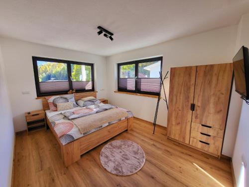 a bedroom with a bed and a television in it at Bergblick Wohnung Posch in Imst