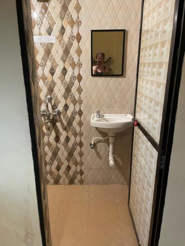 a bathroom with a sink and a mirror at NO NAME GUESTHOUSE in Arambol