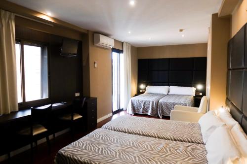 Postel nebo postele na pokoji v ubytování Hotel Benetusser