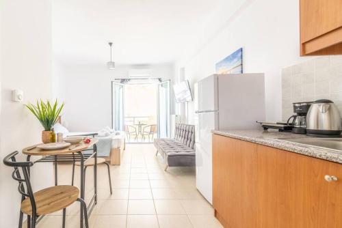 a kitchen with a table and a refrigerator at Urban Apt Next University 20 in Heraklio Town