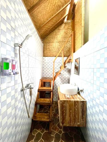 a bathroom with a staircase and a sink and a shower at Coastal Inn Penida in Nusa Penida