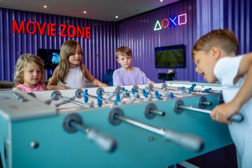 a group of children playing a game in a room at Centara Mirage Beach Resort Dubai in Dubai