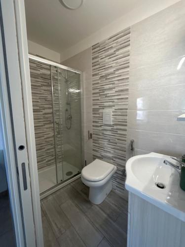 uma casa de banho com um WC, um chuveiro e um lavatório. em La Julienne Green em Nápoles
