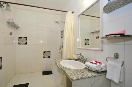 a bathroom with a sink and a shower at Jaipur Vintage House in Jaipur