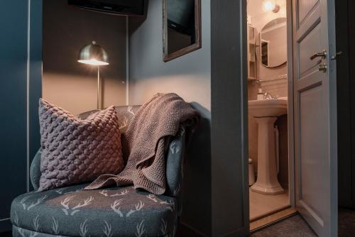 Pokój z kanapą, umywalką i lampą w obiekcie Trillevallens Högfjällshotell & Lägenheter w mieście Trillevallen