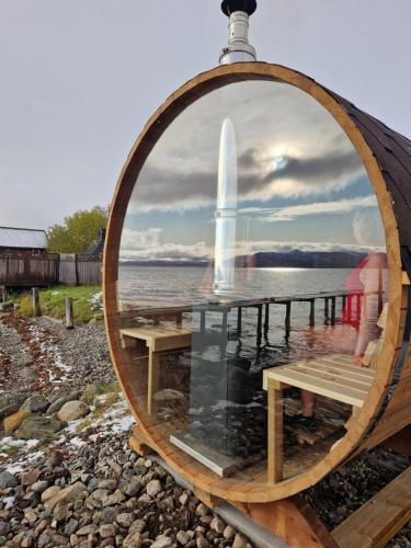 a large wooden barrel with a table and a fountain at Yggdrasil farmhotel retreat & spa in Straumsbukta