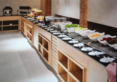 a kitchen with many plates of food on a counter at Ondas Praia Resort in Porto Seguro