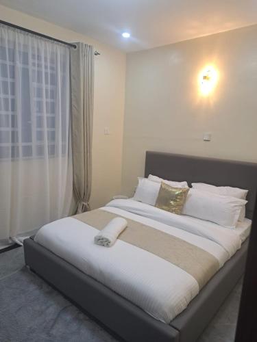 Ένα ή περισσότερα κρεβάτια σε δωμάτιο στο Elysian Homes Nakuru