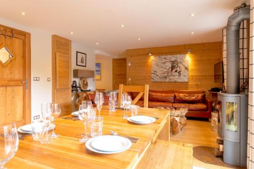 a dining room with a table with wine glasses on it at ORTA Chalet in Les Gets