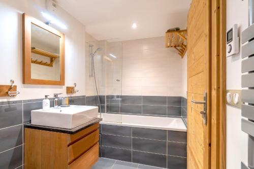 a bathroom with a sink and a shower at ORTA Chalet in Les Gets