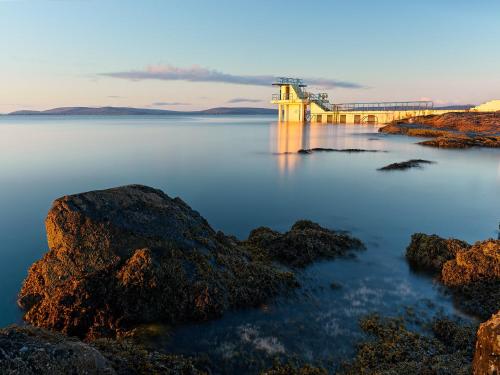 a view of a bridge over a body of water at Cosy beachfront apartment in Salthill Galway city in Galway