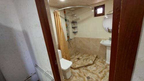 a bathroom with a toilet and a sink at Geghama Resort and Tours in Geghard