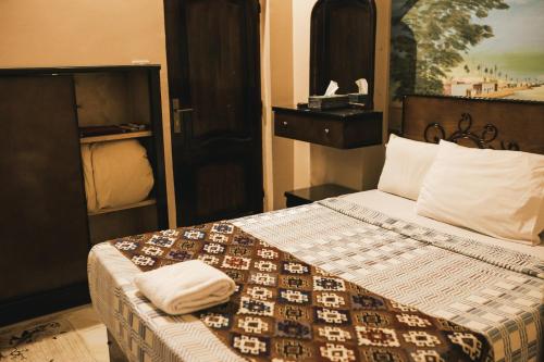 a bedroom with a bed with two towels on it at Tuya Hotel in Abu Simbel