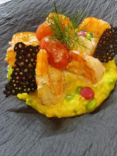 a plate of food with vegetables on top at Villa Patriot Boutique Hotel in Mariánské Lázně