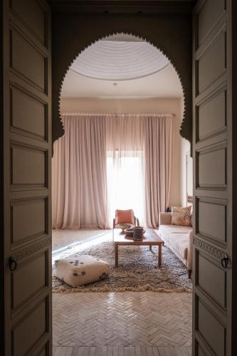 a living room with a couch and a window at Domaine Des Remparts Hotel & Spa in Marrakech