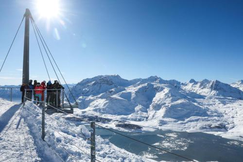 a group of people standing on a ski lift in the snow at Grand Studio Val Cenis in Lanslebourg-Mont-Cenis