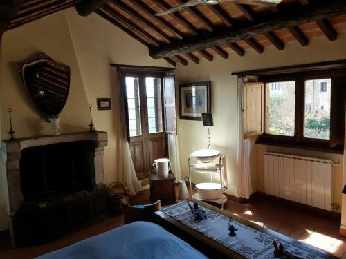 a living room with a bed and a fireplace at il sogno di Civita in Bagnoregio
