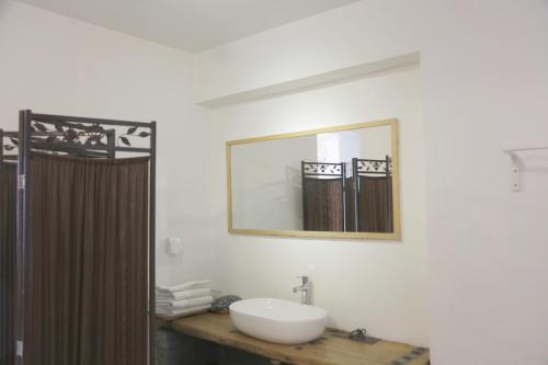 a bathroom with a sink and a mirror at Xi'an Travelling with Hotel South Gate in Xi'an