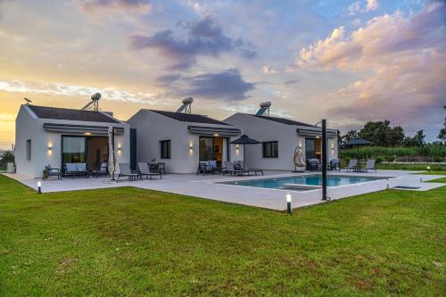 a house with a swimming pool in the yard at Vathy Villas in Preveza
