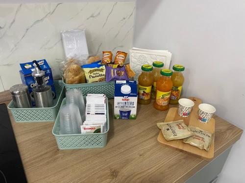 a counter with two baskets of food and drinks on it at Isla Home in Naples