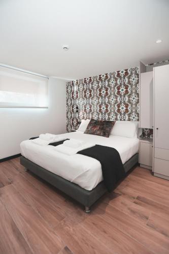 a bedroom with a large bed with a wall at Alma Candida 01 in Valença