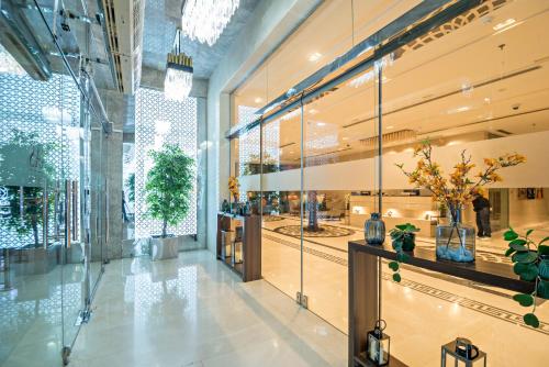 a lobby with plants and vases on display at Jiwar Hotel in Jeddah