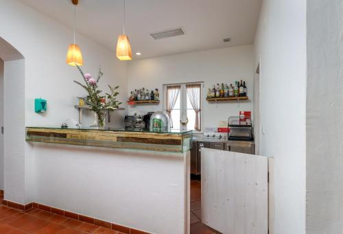 a kitchen with white walls and a counter at Monte do Giestal - Casas de Campo & Spa in Abela