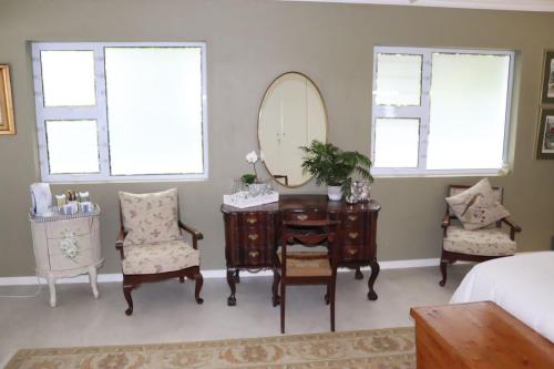 a bedroom with a dressing table and a mirror at Bo-Yoga in Ramsgate