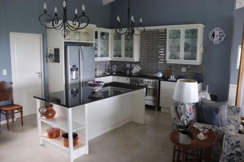 a kitchen with a refrigerator and a table in it at Bo-Yoga in Ramsgate