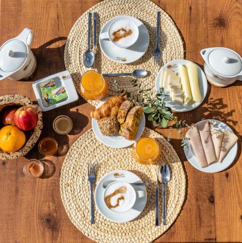 a table with plates of breakfast food on it at Monte do Giestal - Casas de Campo & Spa in Abela