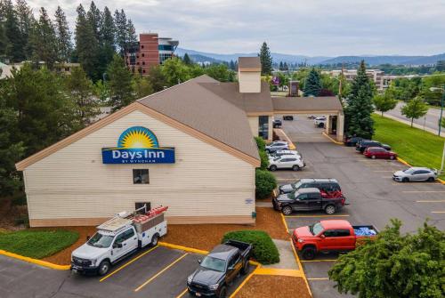 a day inn with cars parked in a parking lot at Days Inn by Wyndham Coeur d'Alene in Coeur d'Alene