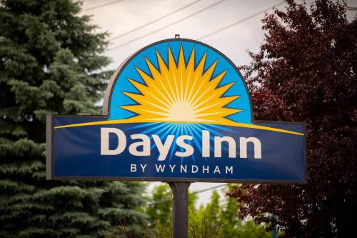 a sign for a dayniannian gas station at Days Inn by Wyndham Coeur d'Alene in Coeur d'Alene